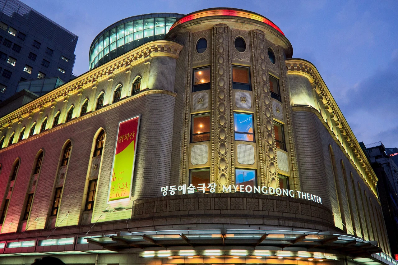 Early-evening Myeongdong shopping street with beauty stores, food stalls and travellers