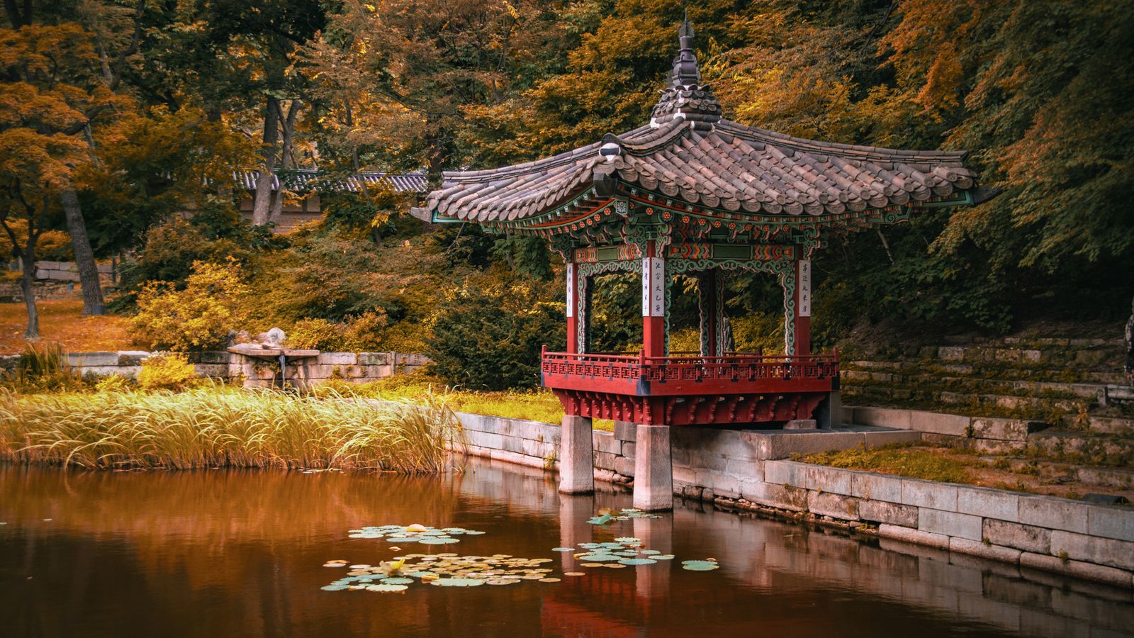 Traditional Korean pavilion surrounded by autumn foliage in Seoul
