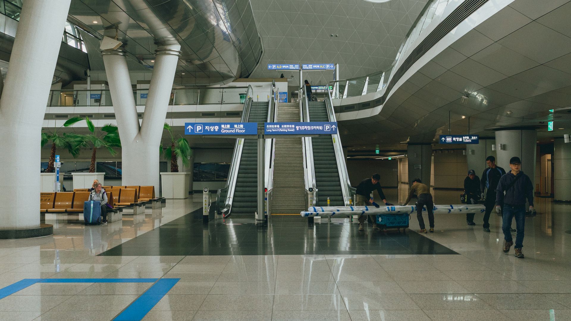Incheon International Airport terminal with escalators and travellers, Korea