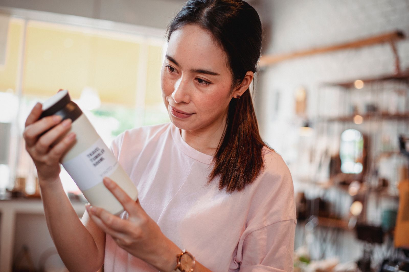 Shopper reading a cosmetic product label in a store
