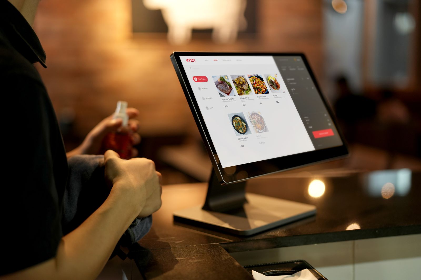 Customer using a touchscreen ordering system in a restaurant