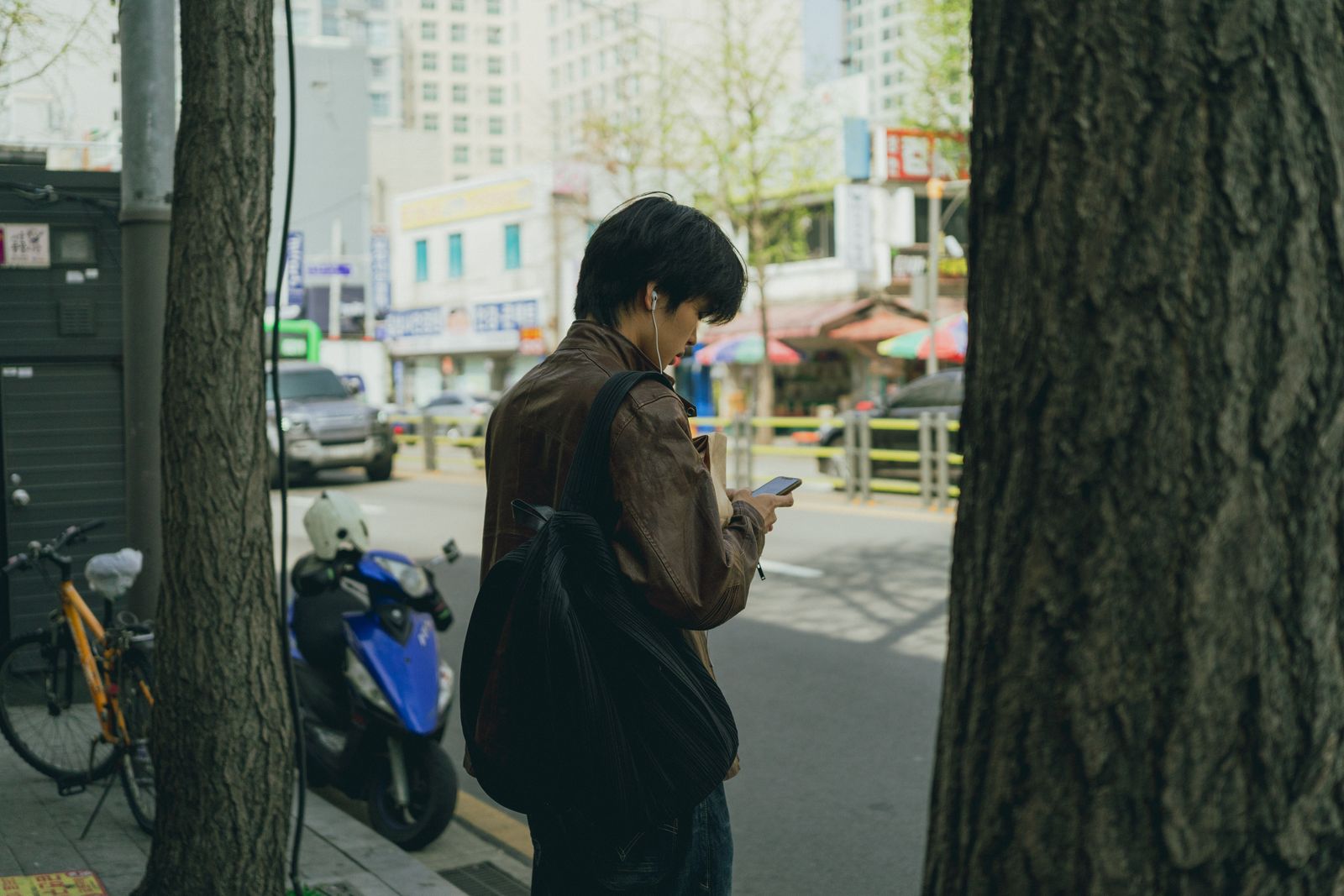 Traveler using a smartphone on a Seoul street