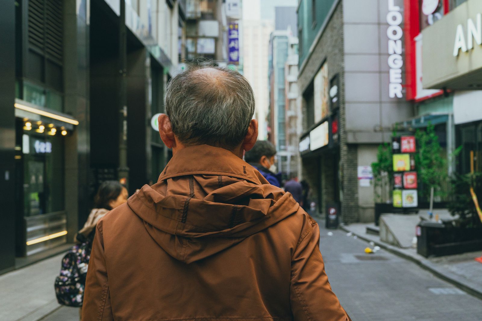 Pedestrians on a modern Seoul shopping street